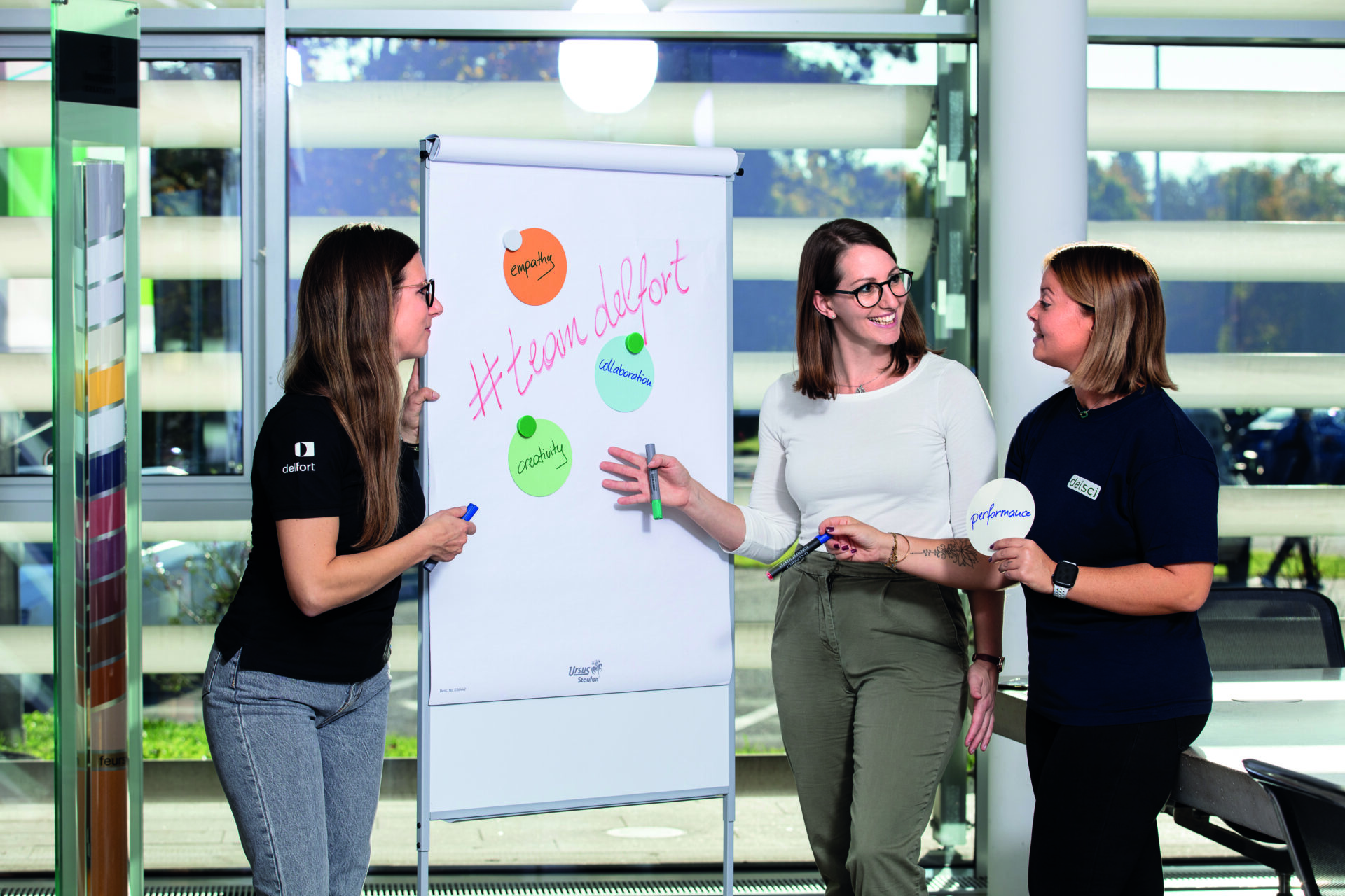 3 women standing in front of a flip chart